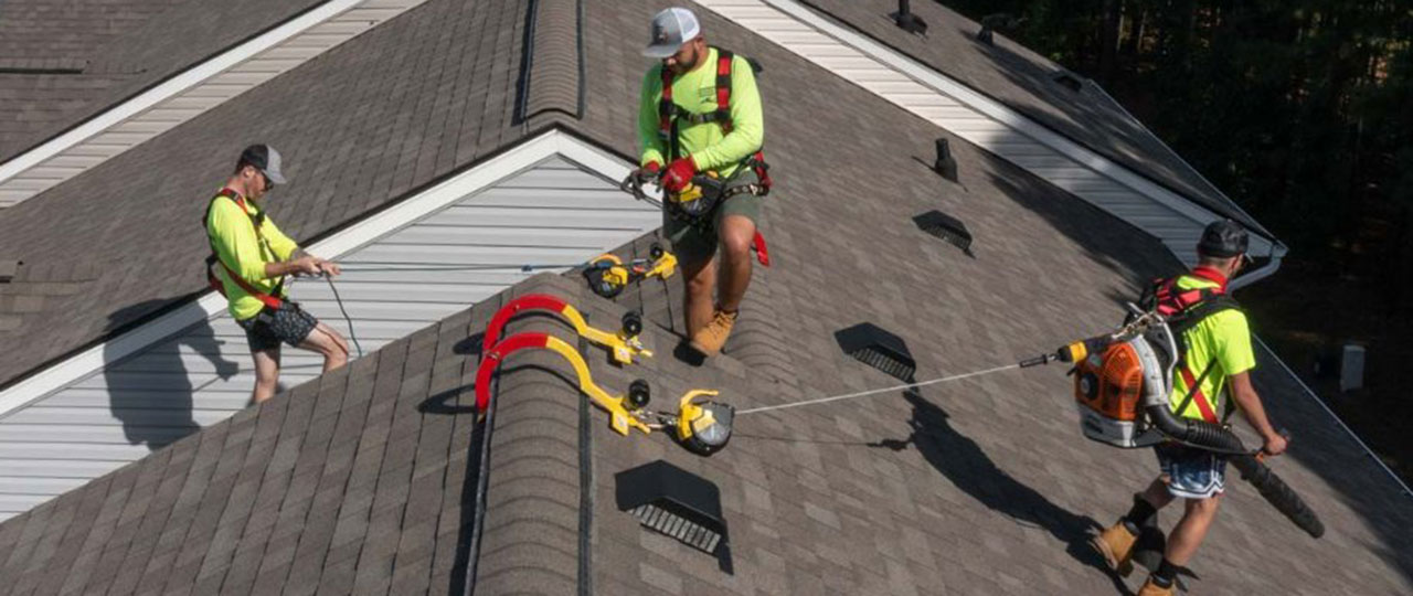 SNS Absolute Roofing roofers conducting cleaning and maintenance